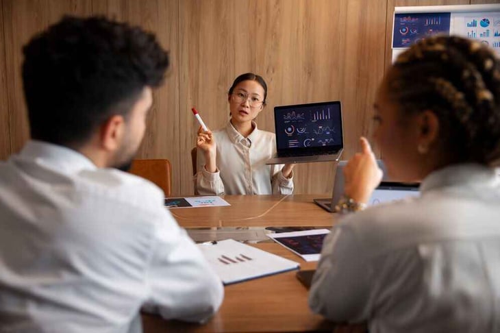 Employees working in the office using digital signage.