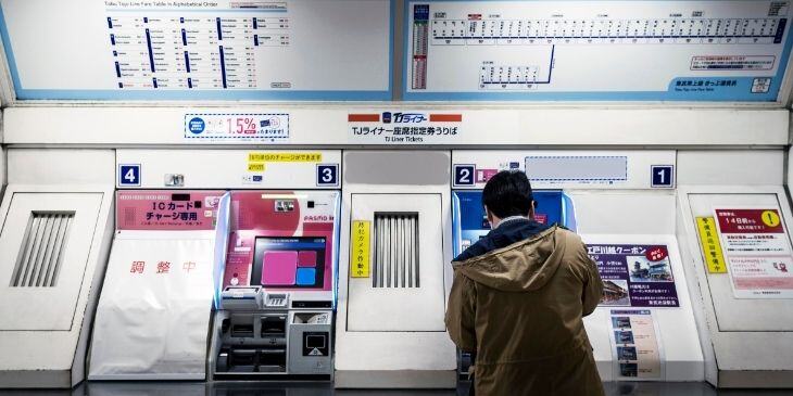  A man on the train looking at passenger information.