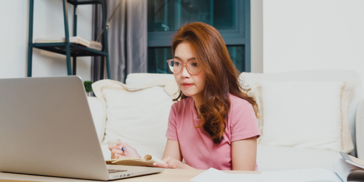 Student watching announcements on a laptop.