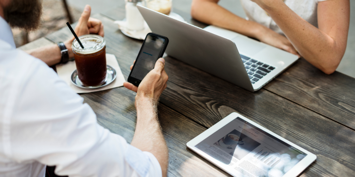 Two people screen-sharing using phone, laptop and tablet.