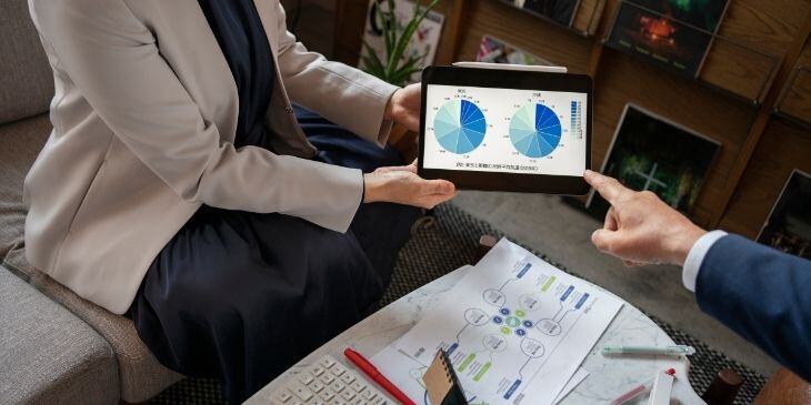 Woman holding a tablet displaying KPIs.