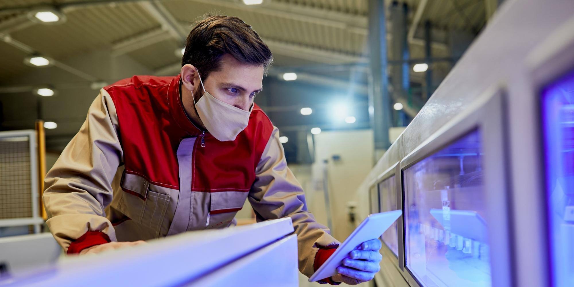 A man working, looking at digital signage.