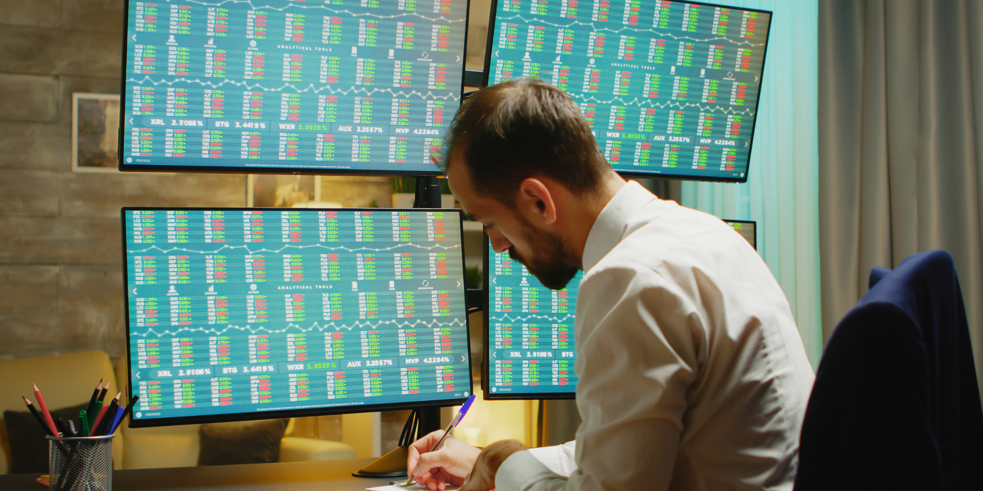 A man working in an office using scoreboards.